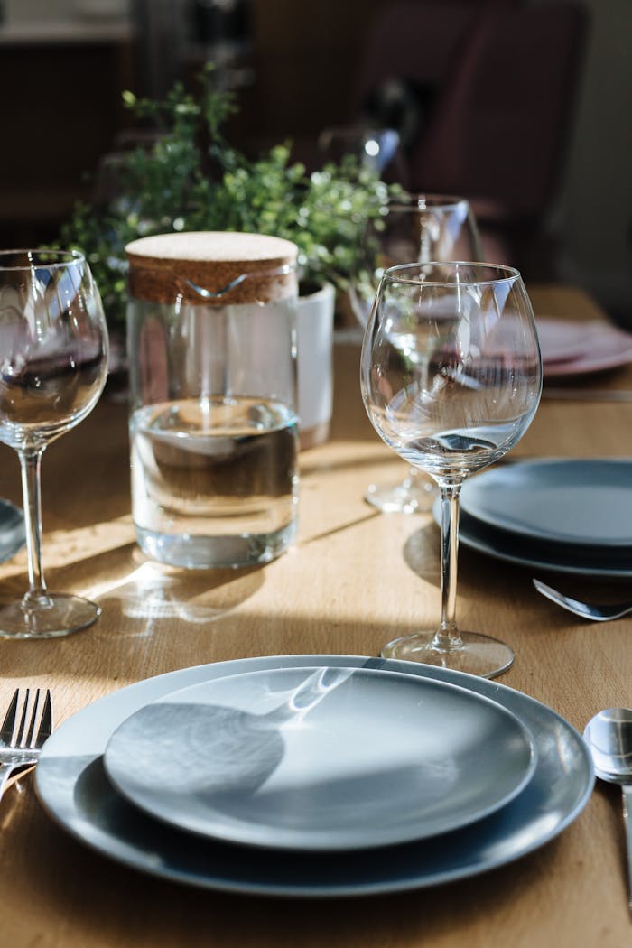 A beautifully arranged dining table with glassware and plates, perfect for a cozy meal.